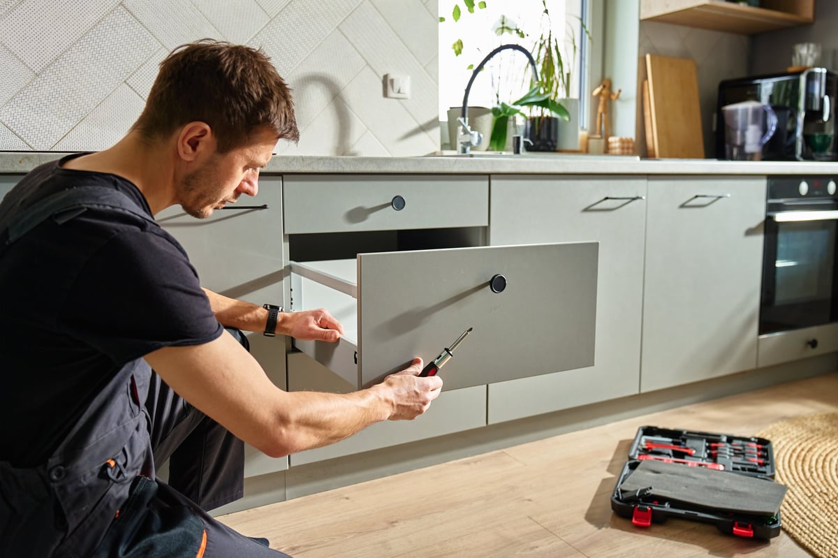 Handyman assembling kitchen drawer