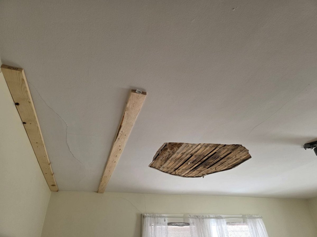 Wooden beams and metal ductwork installed on ceiling during construction or renovation